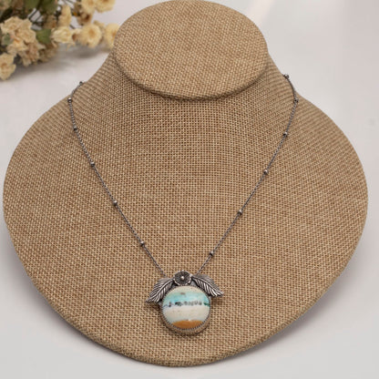 Handmade sterling silver necklace with opalized petrified wood and floral accents.