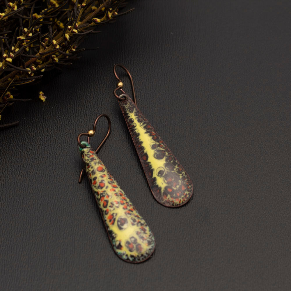 Brown, orange, and yellow enamel teardrop earrings with autumn-inspired texture and niobium ear wires, handmade by Divella Designs.