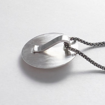 Back of sterling silver fox pendant showing the hidden handmade bail.