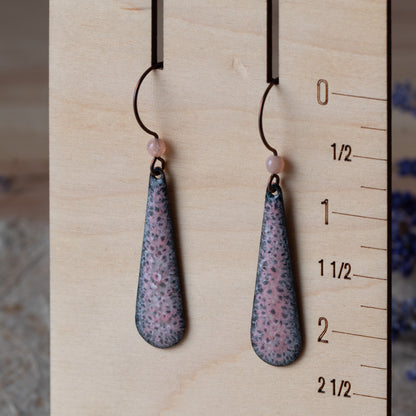 Pink enamel teardrop earrings with dark speckled detail, rose quartz beads, and niobium ear wires.