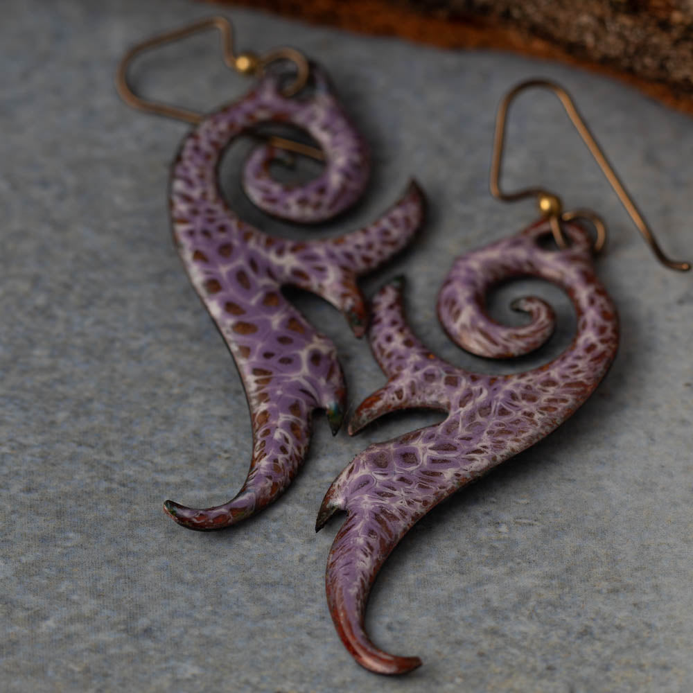 Handmade seaform curl earrings in kiln-fired enamel on copper with niobium ear wires. Lightweight, sculptural, and nature-inspired.