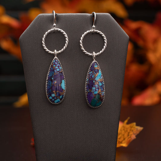 Purple Mohave turquoise sterling silver earrings with long teardrop stones, bronze matrix, fine silver settings, textured hoops, and sterling silver ear wires, handmade by Divella Designs.