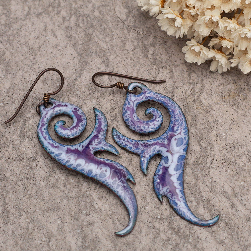 Purple and white enamel swirl dangle earrings with organic shapes and oxidized copper ear wires.