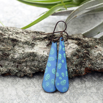 Handmade blue and green enamel teardrop earrings with oxidized copper ear wires.