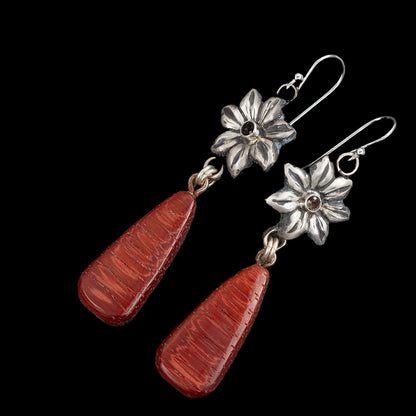 Handcrafted dangle earrings with rich red Bubinga wood teardrops and sterling silver flower tops featuring smokey quartz gemstone centers – artisan nature-inspired jewelry by Divella Designs, shown on black background.