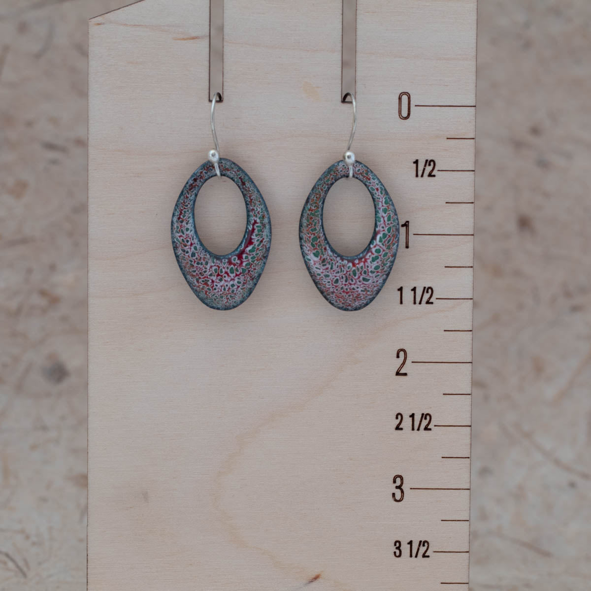 Oval enamel earrings for scale