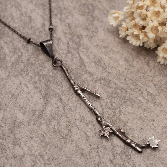 Handmade fused sterling silver necklace with detailed 3 1/4" branch pendant and tiny maple leaves on an 18-inch oxidized chain, woodland nature jewelry.