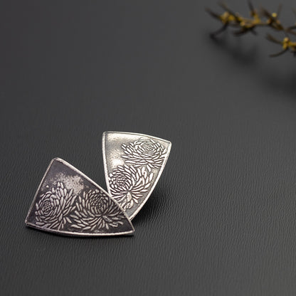 Sterling silver chrysanthemum earrings with etched floral design, handmade botanical jewelry with oxidized finish and modern triangular shape.