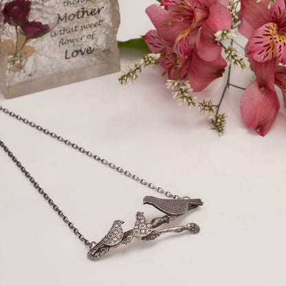 Sterling silver Storytime Necklace featuring three textured birds on a branch, artisan handmade nature-inspired jewelry.