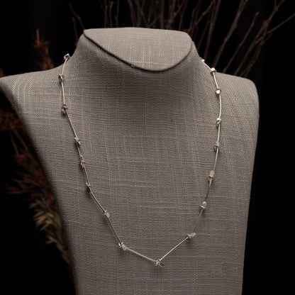 Minimalist sterling silver necklace with handcrafted paddle links and blossom-like accents – modern artisan jewelry