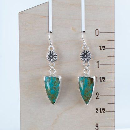 Handmade Kingman turquoise dangle earrings with fine silver bezel and sterling silver floral accents, artisan crafted in Vermont.