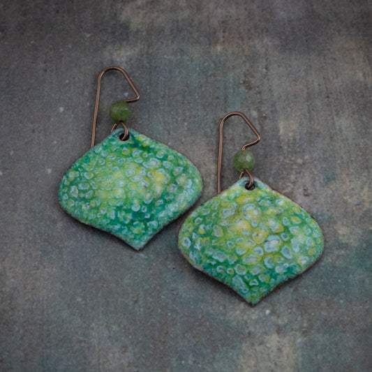 Artisan enamel earrings in soft green and yellow tones with lichen-like texture, handmade on copper with niobium ear wires.