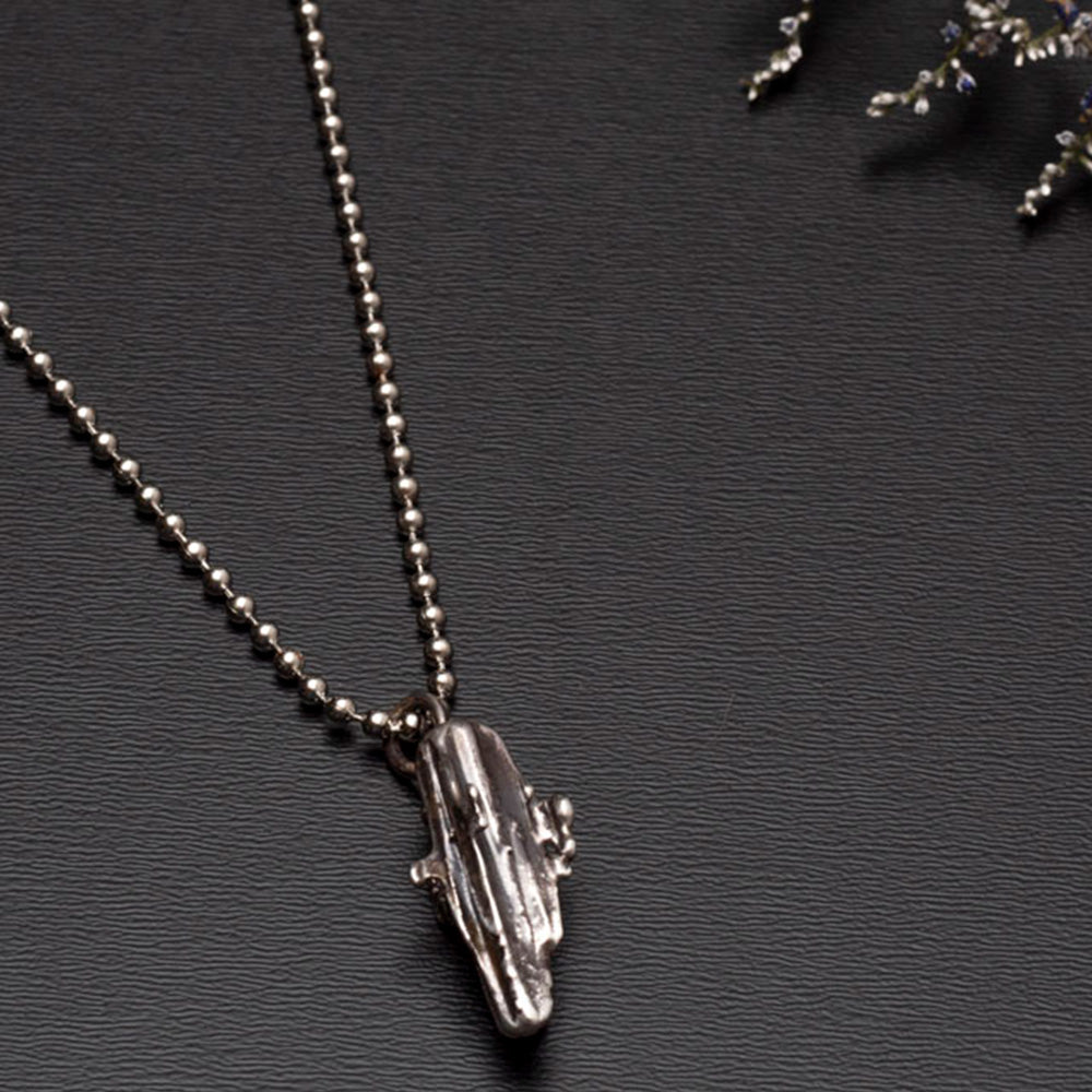 sterling silver broomcast necklace on black background