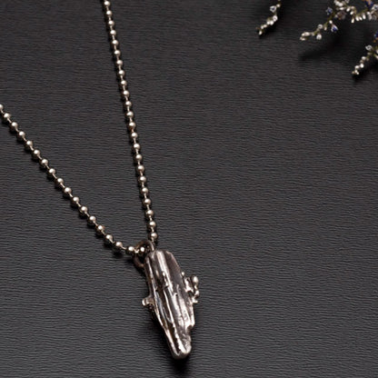 sterling silver broomcast necklace on black background