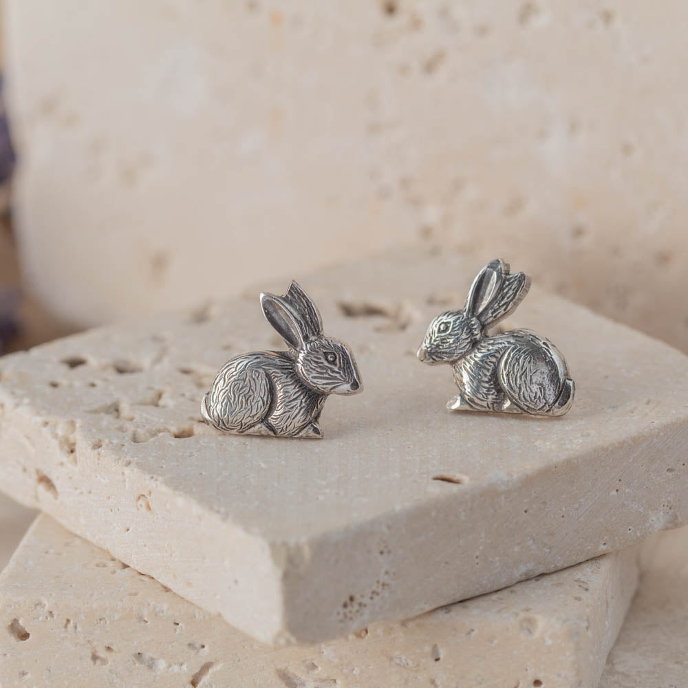sterling silver bunny stud earrings on stone background