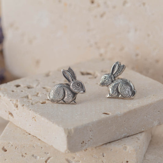 sterling silver bunny stud earrings on stone background