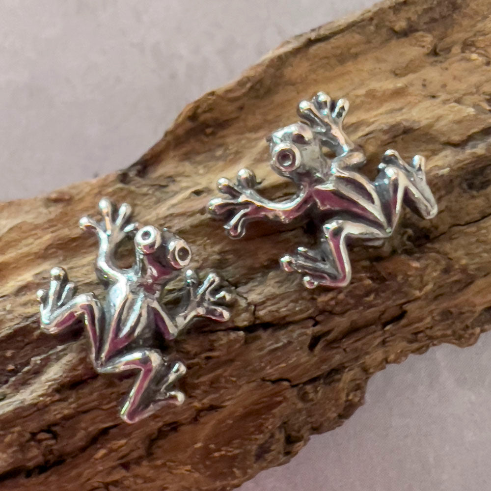 Sterling silver frog stud earrings with playful design, small nature-inspired animal jewelry.