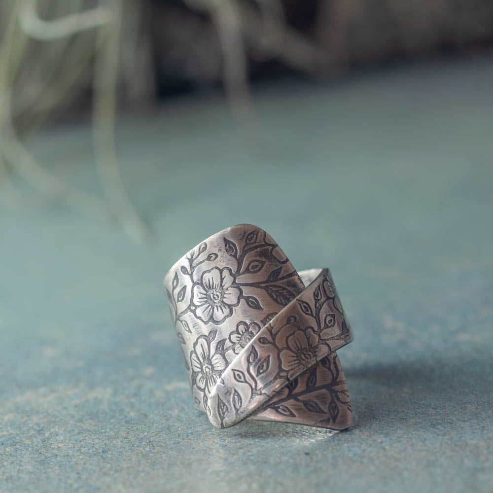 Sterling silver wildflower wrap ring with botanical flower texture and open handmade design, crafted in Vermont by Divella Designs.