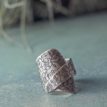 Sterling silver wildflower wrap ring with botanical flower texture and open handmade design, crafted in Vermont by Divella Designs.