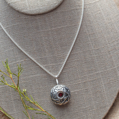 Sterling silver and garnet necklace with nature-inspired texture and handmade finish, crafted in Vermont by Divella Designs.