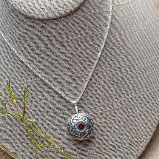Sterling silver and garnet necklace with nature-inspired texture and handmade finish, crafted in Vermont by Divella Designs.