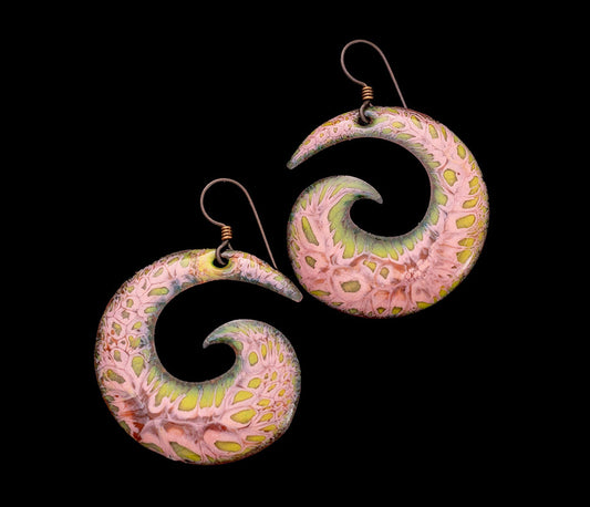 Handmade copper enamel earrings in pink and green spiral wave design with niobium ear.