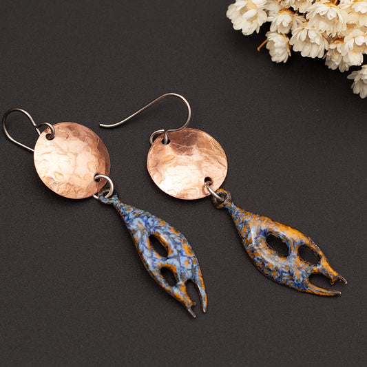 Handmade copper and enamel earrings with organic shape and hammered disc in sunset blue and ocean orange.