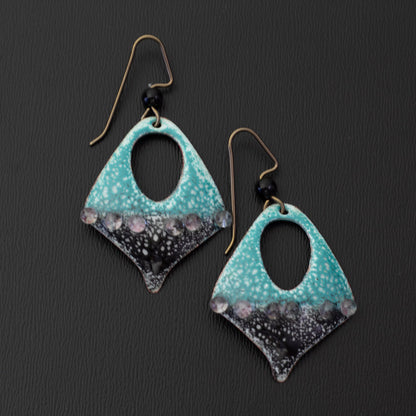 Teardrop cutout enamel earrings in teal and black with raised dot accents, handmade on copper with niobium ear wires and glass bead detail.