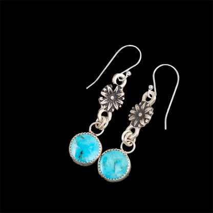 Turquoise sterling silver drop earrings with fine silver settings, floral accents, and sterling silver ear wires, handmade in Vermont by Divella Designs.