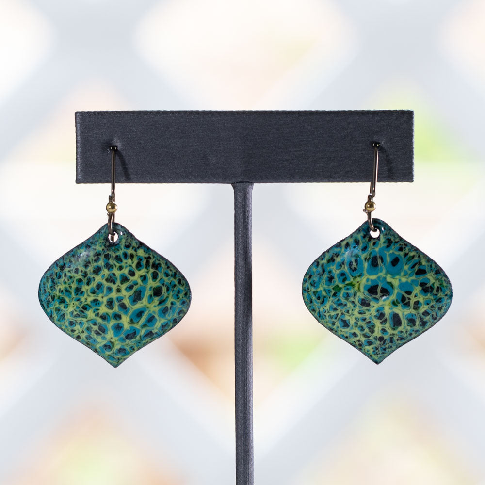 Handmade enameled earrings in vibrant turquoise and yellow-green with organic abstract patterns and curved diamond shape, artisan jewelry design.