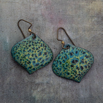 Handmade enameled earrings in vibrant turquoise and yellow-green with organic abstract patterns and curved diamond shape, artisan jewelry design. Hypoallergenic niobium makes wearable for anyone.
