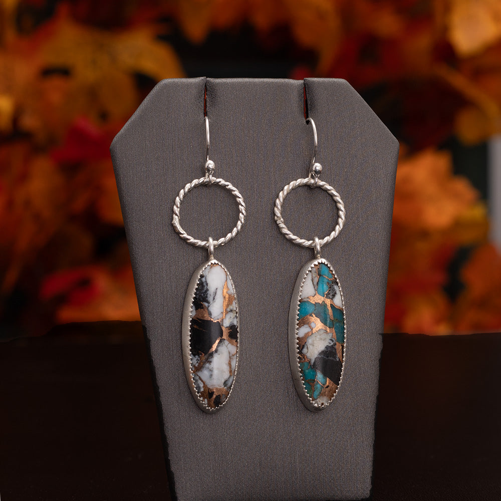 White Buffalo Kingman turquoise composite earrings with bronze matrix, fine silver settings, textured sterling silver hoops, and sterling silver ear wires, handmade by Divella Designs.