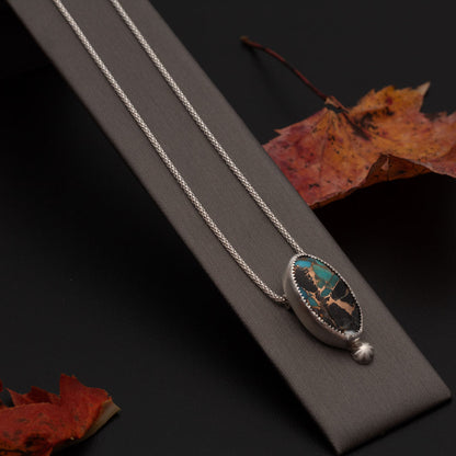 White Buffalo Kingman turquoise composite necklace with blue turquoise, white stone, bronze matrix, sterling silver setting, and 18 inch chain by Divella Designs.