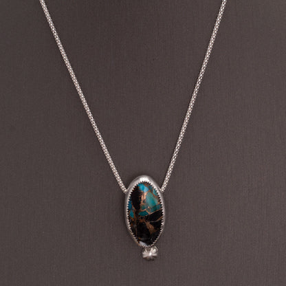 White Buffalo Kingman turquoise composite necklace with blue turquoise, white stone, bronze matrix, sterling silver setting, and 18 inch chain by Divella Designs.