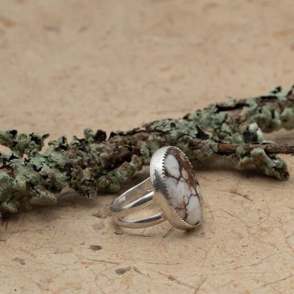 Silver and Wild Horse stone ring on bark with lichen covered branch on the background