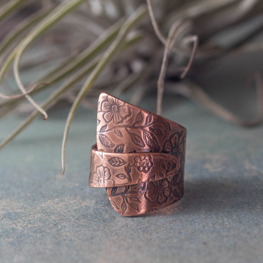 Handmade copper floral ring adjustable in natural light with soft minimalist styling