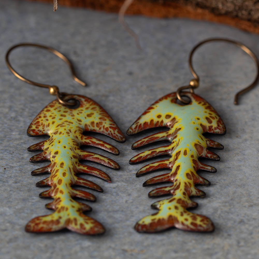 Colorful kiln-fired enamel fishbone earrings on copper with niobium ear wires, handmade by Divella Designs in Vermont.
