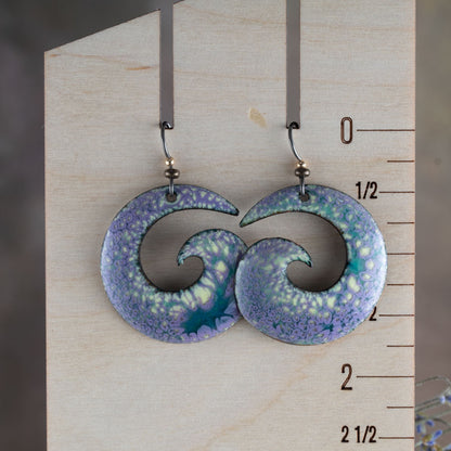 Purple, yellow, and blue enamel spiral earrings shown for scale with niobium ear wires and open spiral shape.