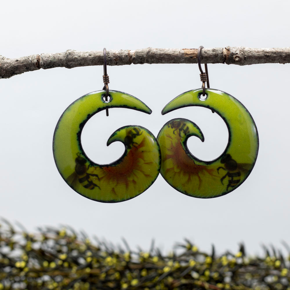 Yellow and black bee enamel spiral earrings with a pollinator-inspired design and niobium ear wires, handmade by Divella Designs.