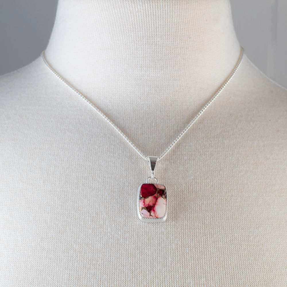 Handcrafted sterling silver pendant necklace with rectangular red and pink dahlia jasper stone, set in a serrated bezel on a delicate chain for a bold floral-inspired look