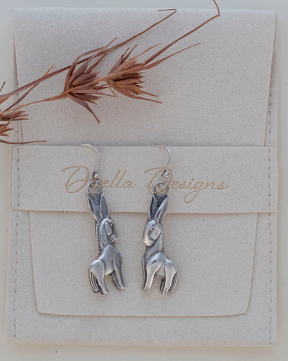 Handmade fine and sterling silver donkey dangle earrings with detailed sculpted design, featuring playful animal-inspired jewelry with artisan charm.