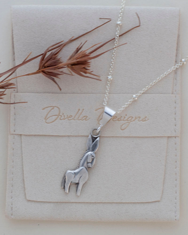 sterling silver donkey necklace on branded pouch
