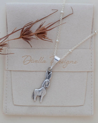 sterling silver donkey necklace on branded pouch