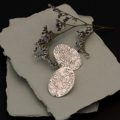 Handmade fine silver oval stud earrings with embossed organic texture, featuring earthy artisan style and oxidized finish for a nature-inspired look