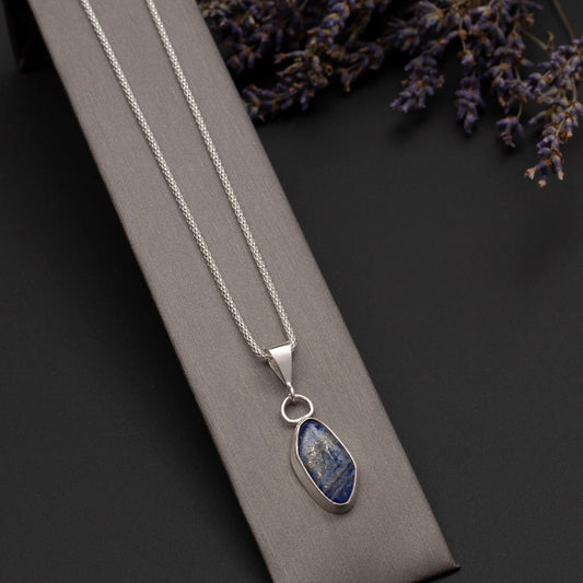 Sterling silver necklace with natural lapis lazuli pendant, set in a sleek bezel on an 18-inch chain, handmade by Divella Designs.