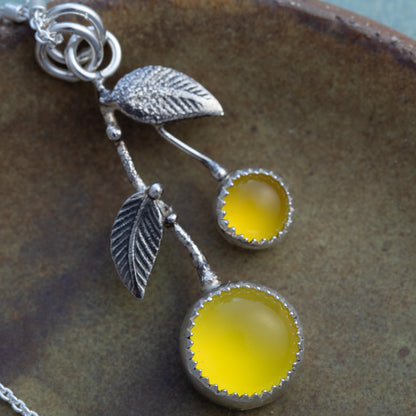 Close-up of yellow chalcedony lemon-inspired pendant with oxidized sterling silver leaves and branch details.