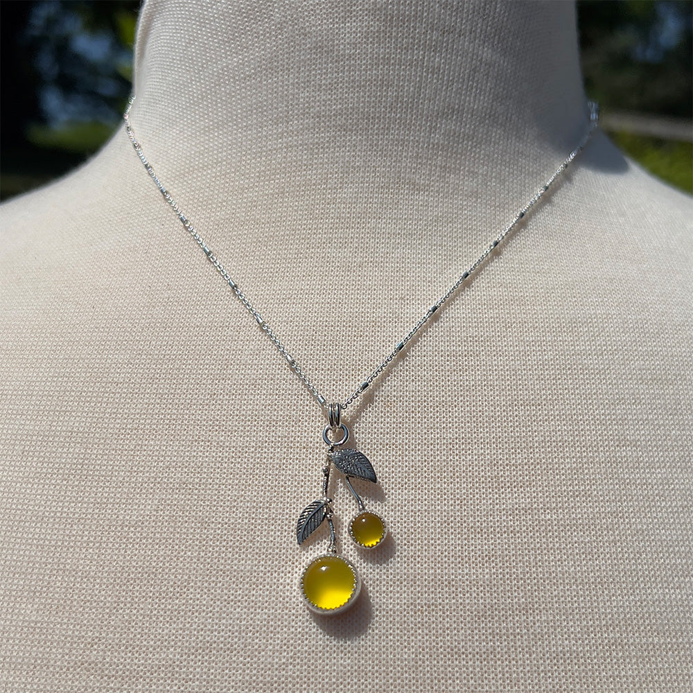 Yellow chalcedony sterling silver necklace shown on a display bust with an 18 inch chain.