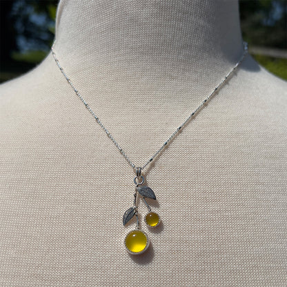 Yellow chalcedony sterling silver necklace shown on a display bust with an 18 inch chain.