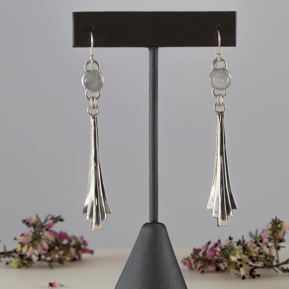 Handmade sterling silver dangle earrings featuring fan-shaped cascading drops and round moonstone gems, with minimalist artisan design and elegant movement.