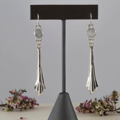 Handmade sterling silver dangle earrings featuring fan-shaped cascading drops and round moonstone gems, with minimalist artisan design and elegant movement.